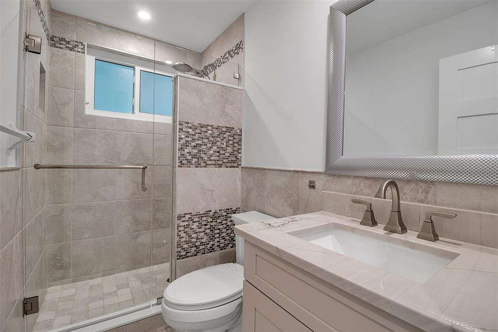 226 Golden Gate Point, Unit 21 Sarasota, FL 34236 - Photo 40 of 55 a bathroom with a granite countertop sink toilet and shower