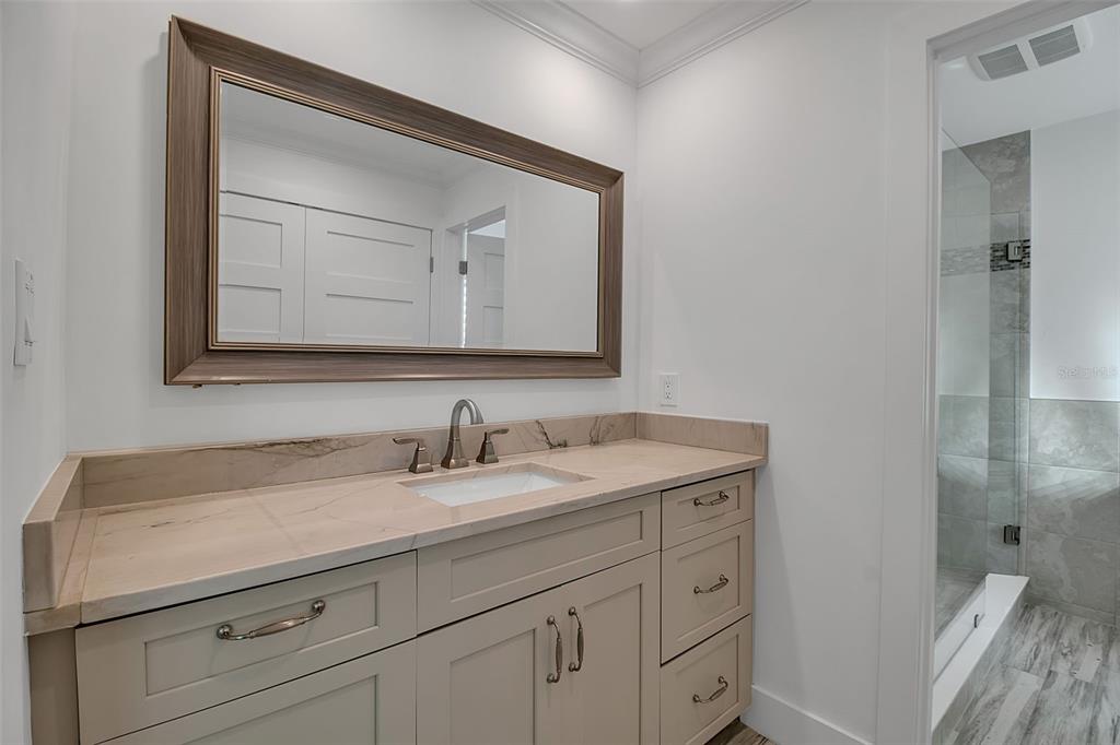 226 Golden Gate Point, Unit 21 Sarasota, FL 34236 - Photo 43 of 55 a bathroom with a sink and a mirror