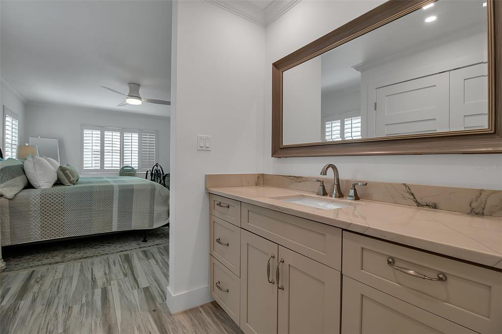 226 Golden Gate Point, Unit 21 Sarasota, FL 34236 - Photo 44 of 55 a en suite bathroom with a granite countertop sink and mirror