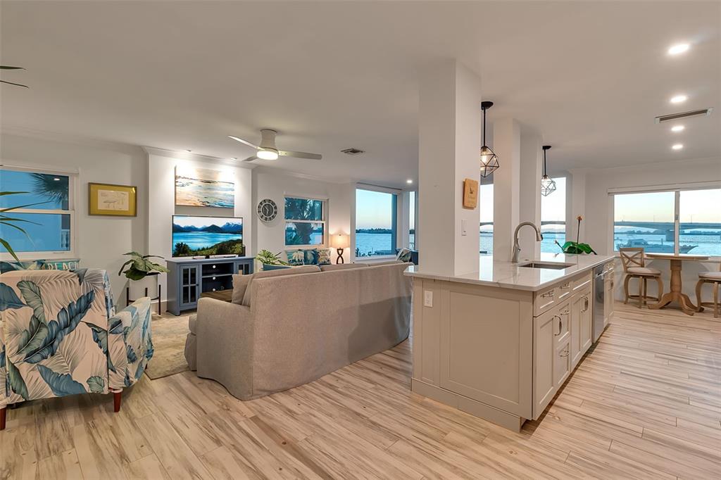 226 Golden Gate Point, Unit 21 Sarasota, FL 34236 - Photo 6 of 55 a large white kitchen with lots of counter space and stainless steel appliances