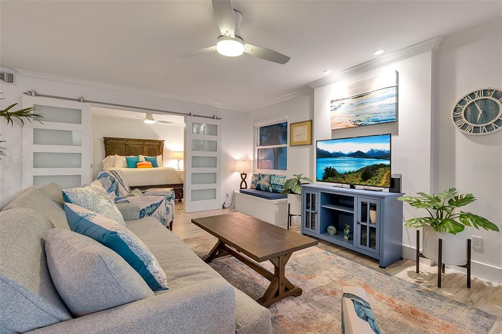 226 Golden Gate Point, Unit 21 Sarasota, FL 34236 - Photo 7 of 55 a living room with furniture a fireplace and a flat screen tv