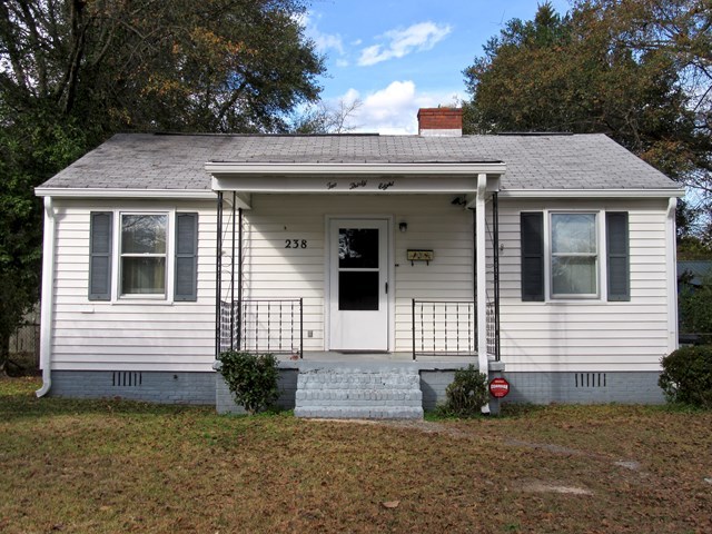 a view of a house with a small yard and a large window