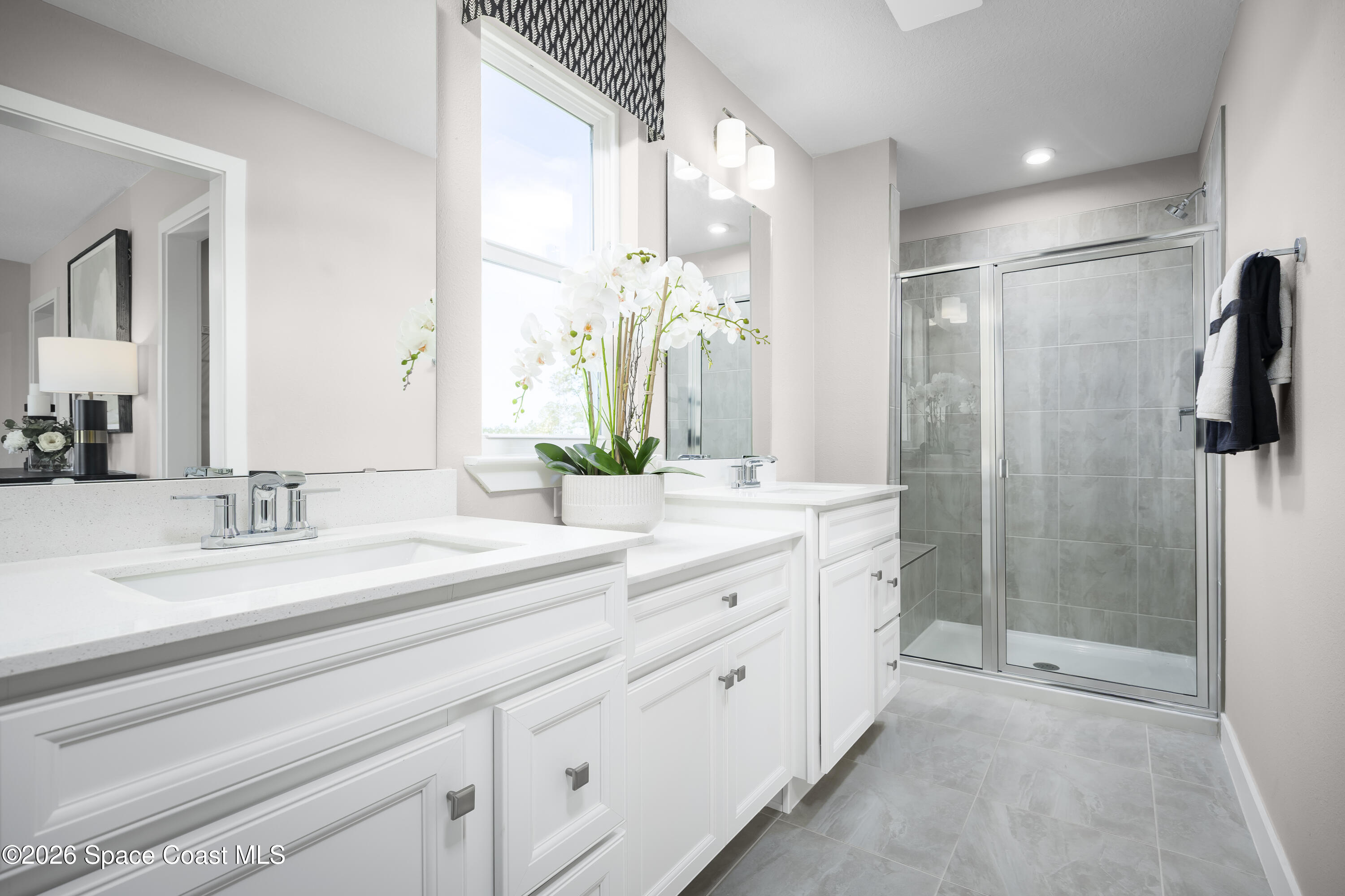 1878 Kendall Pointe Place Melbourne, FL 32935 - Photo 13 of 15 a spacious bathroom with a double vanity sink mirror and shower