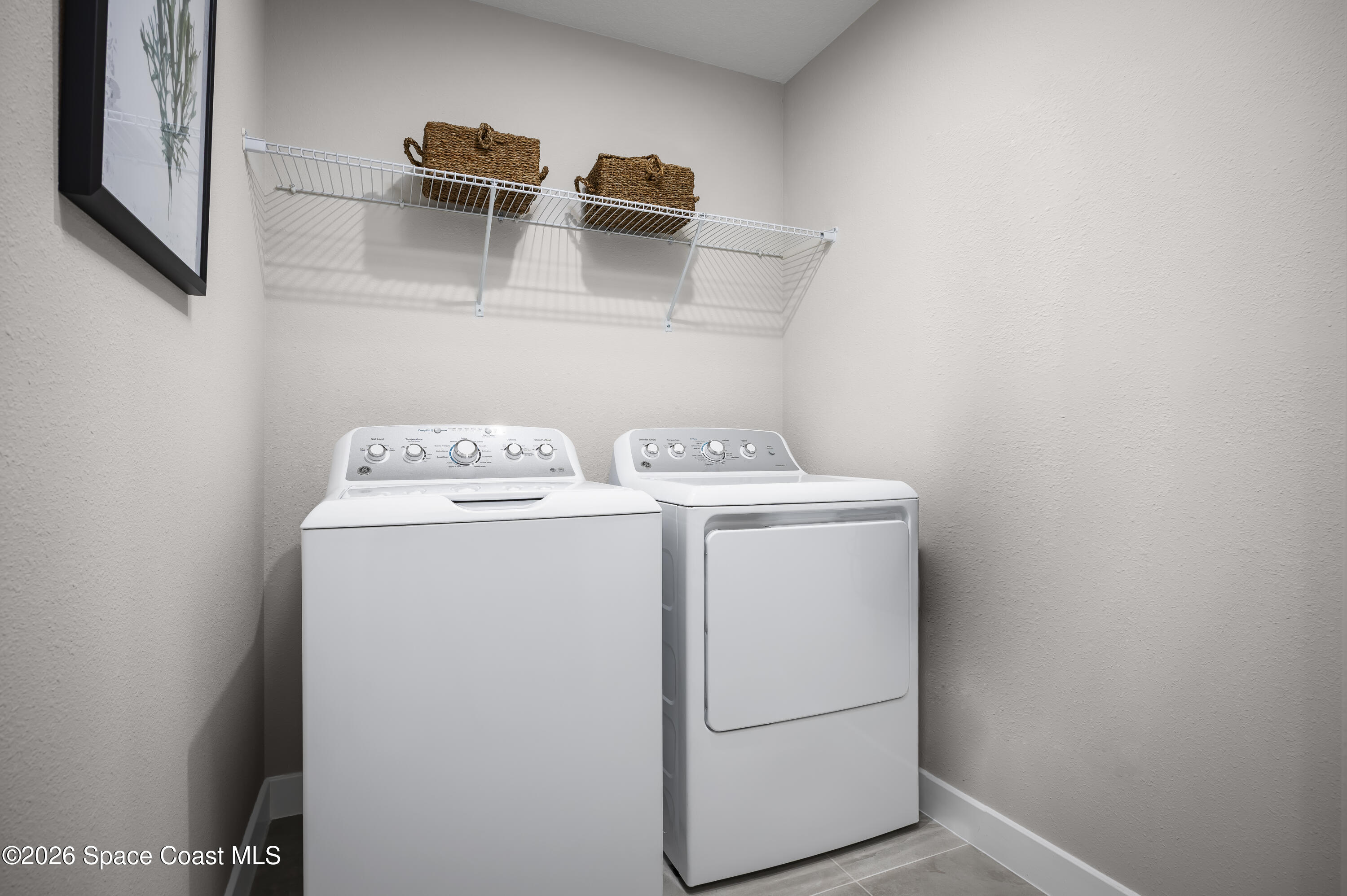 1878 Kendall Pointe Place Melbourne, FL 32935 - Photo 15 of 15 a utility room with dryer and washer