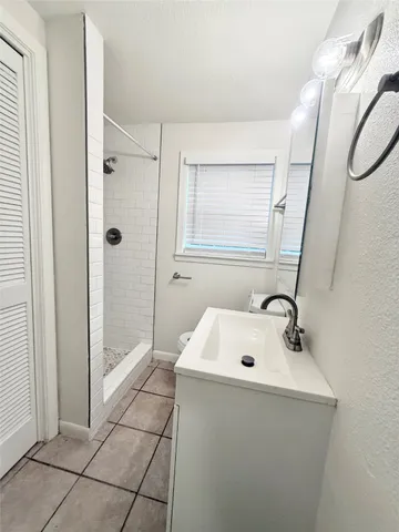a bathroom with a sink a mirror and shower