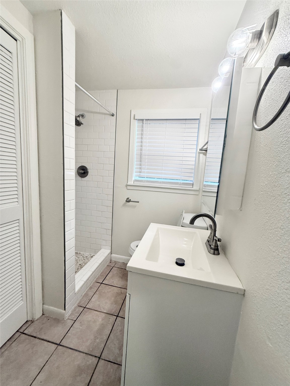 2714 Carrolton Street, Unit BACK Houston, TX 77023 - Photo 11 of 14 a bathroom with a sink a mirror and shower