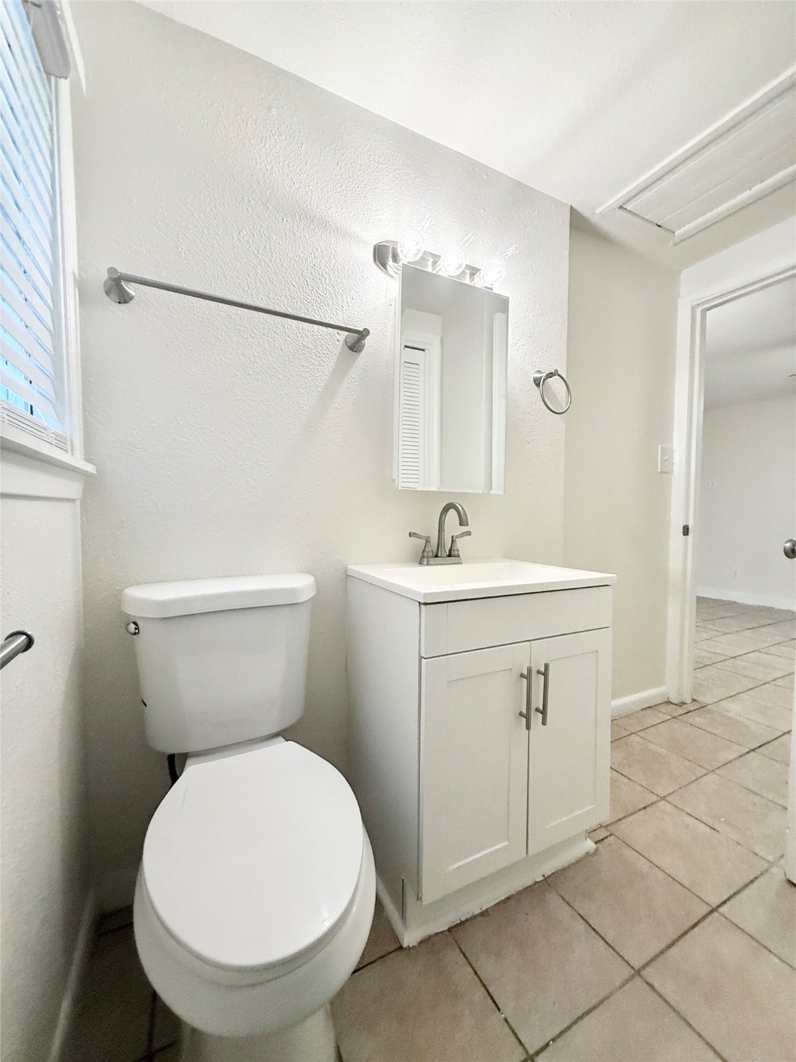 2714 Carrolton Street, Unit BACK Houston, TX 77023 - Photo 12 of 14 a bathroom with a sink mirror vanity and toilet