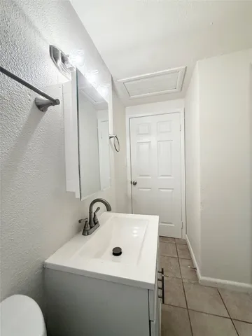 a bathroom with a sink a toilet and mirror