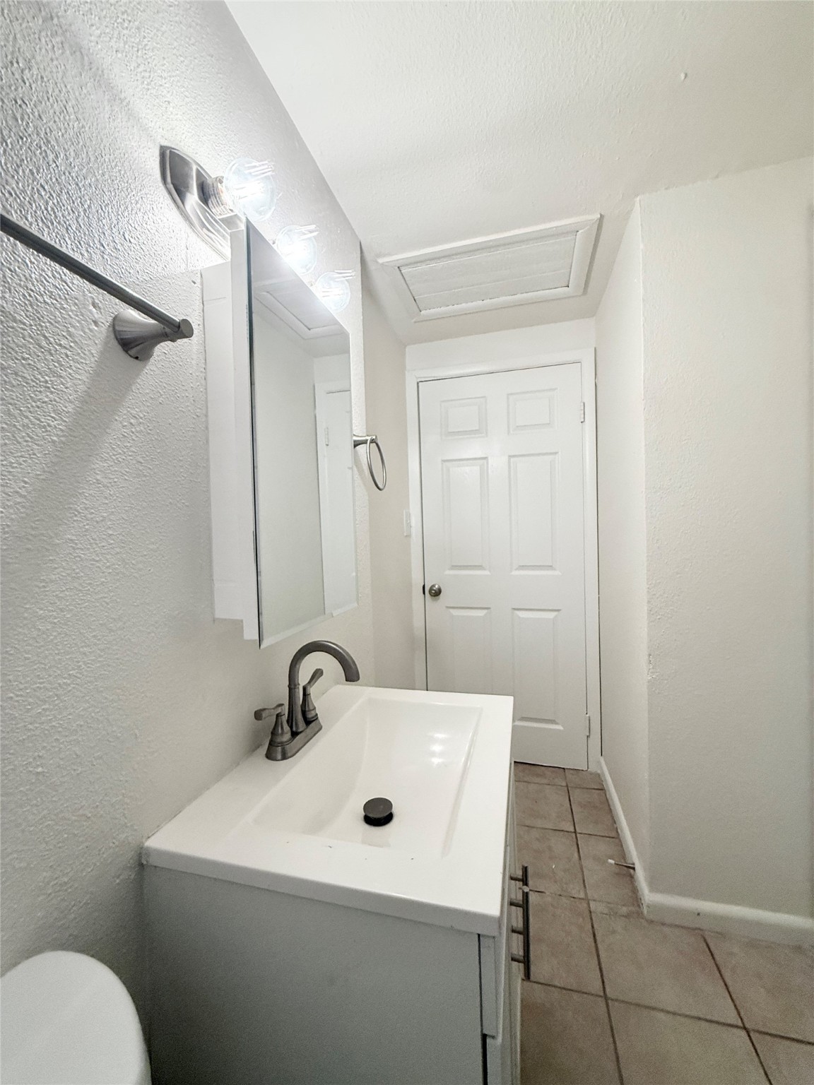 2714 Carrolton Street, Unit BACK Houston, TX 77023 - Photo 14 of 14 a bathroom with a sink a toilet and mirror