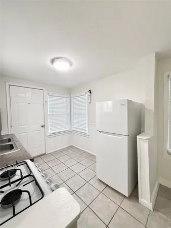 a kitchen with a refrigerator and a stove