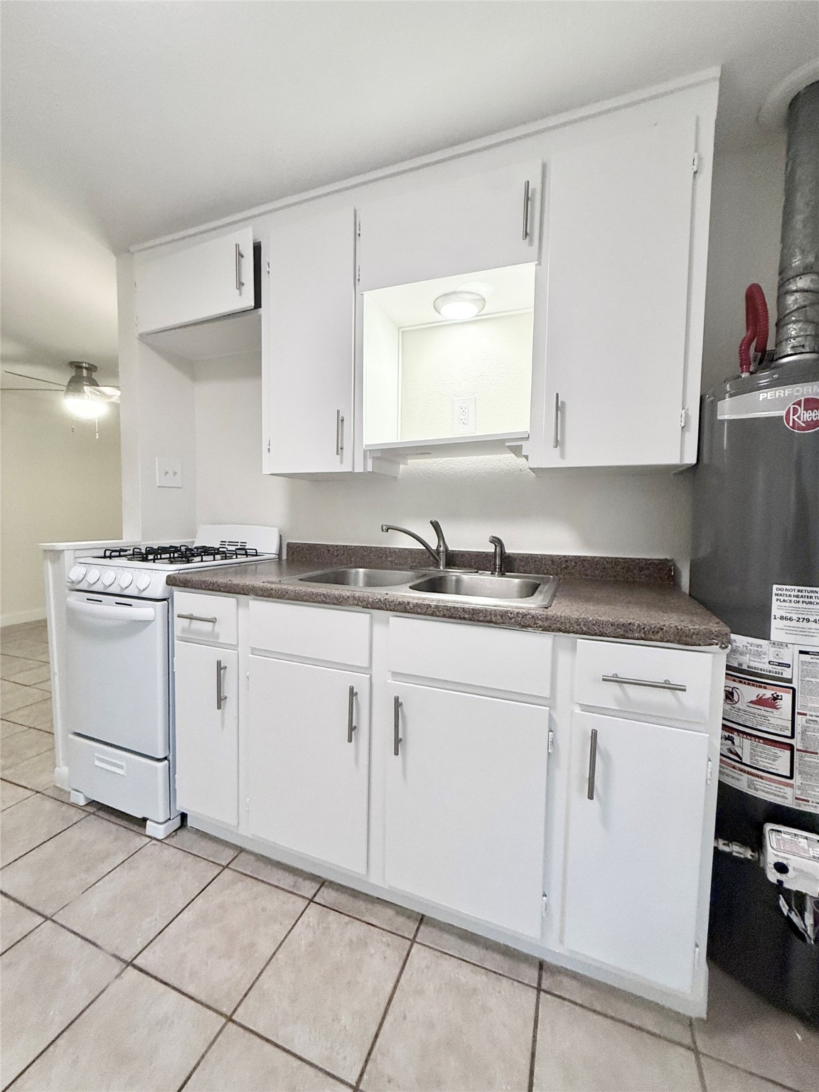 2714 Carrolton Street, Unit BACK Houston, TX 77023 - Photo 9 of 14 a kitchen with granite countertop white cabinets and white appliances