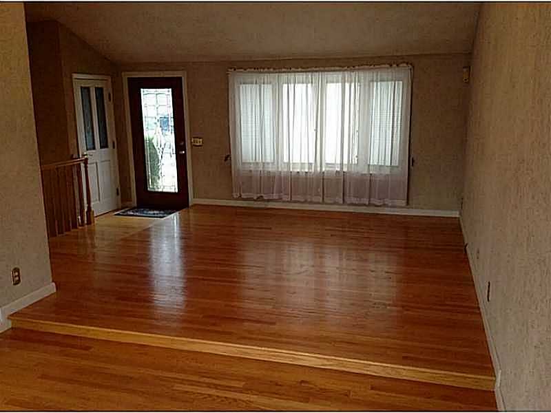 46 Oneida Street Pawtucket, RI 02860 - Photo 19 of 19 Living Room. OPen floor plan living and dining with beautiful hardwood floors.