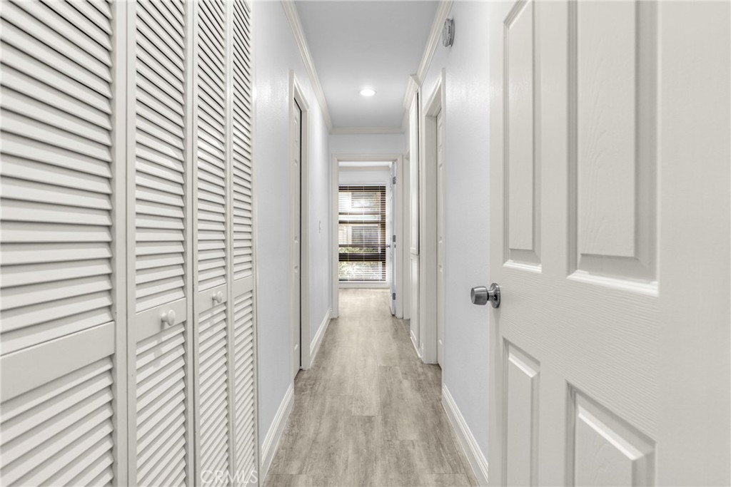 7765 West 91st Street, Unit F1113 Playa del Rey, CA 90293 - Photo 15 of 41 a view of a hallway with wooden floor