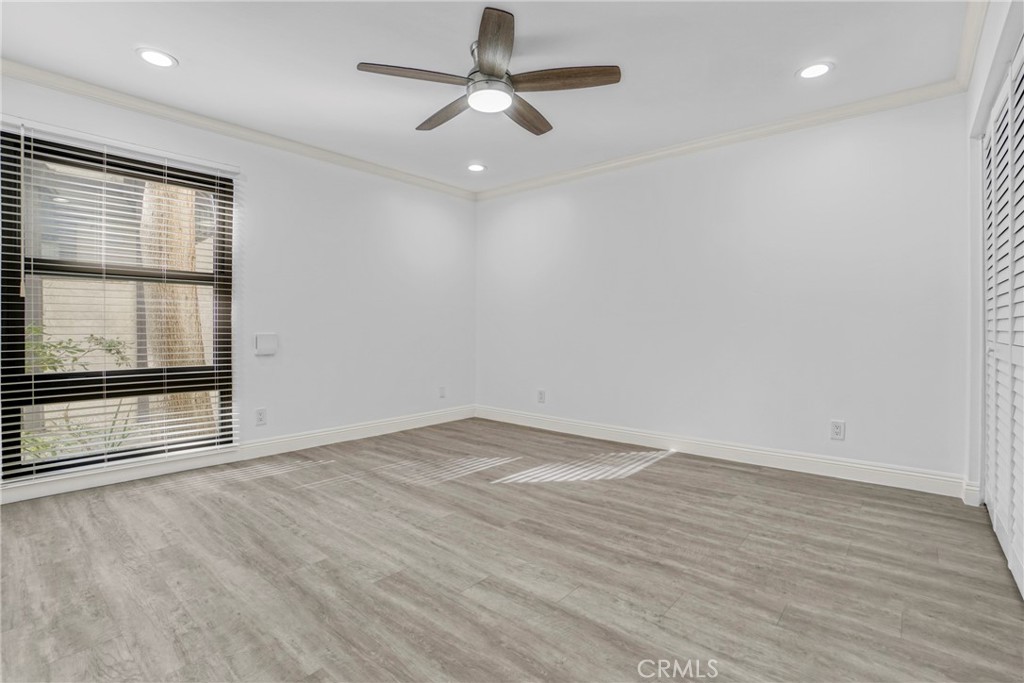 7765 West 91st Street, Unit F1113 Playa del Rey, CA 90293 - Photo 17 of 41 an empty room with wooden floor and windows