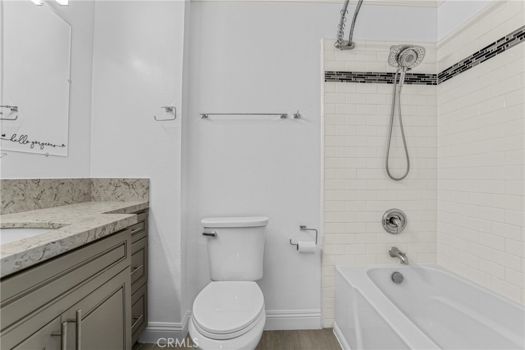 7765 West 91st Street, Unit F1113 Playa del Rey, CA 90293 - Photo 18 of 41 a bathroom with a granite countertop bathtub shower sink vanity and toilet