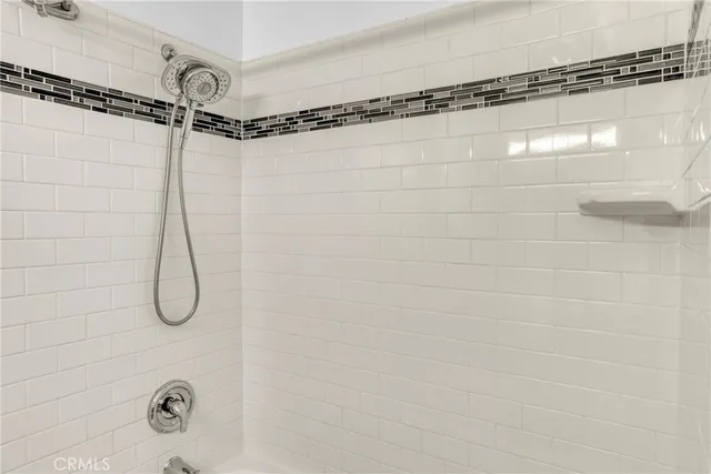 a bathroom with a granite countertop shower a sink and a mirror