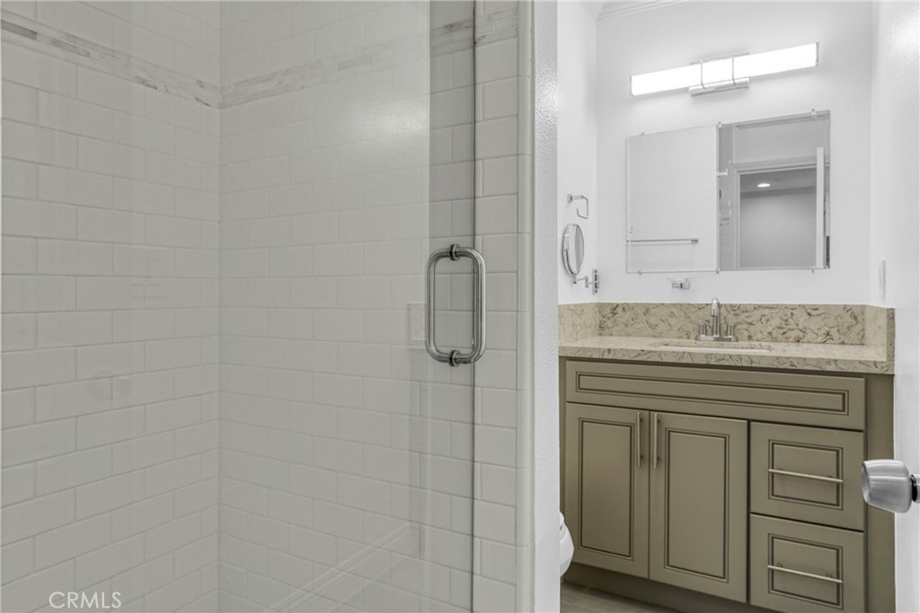 7765 West 91st Street, Unit F1113 Playa del Rey, CA 90293 - Photo 23 of 41 a bathroom with a granite countertop shower a sink and a mirror