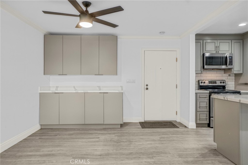7765 West 91st Street, Unit F1113 Playa del Rey, CA 90293 - Photo 4 of 41 a view of kitchen with granite countertop cabinets and refrigerator