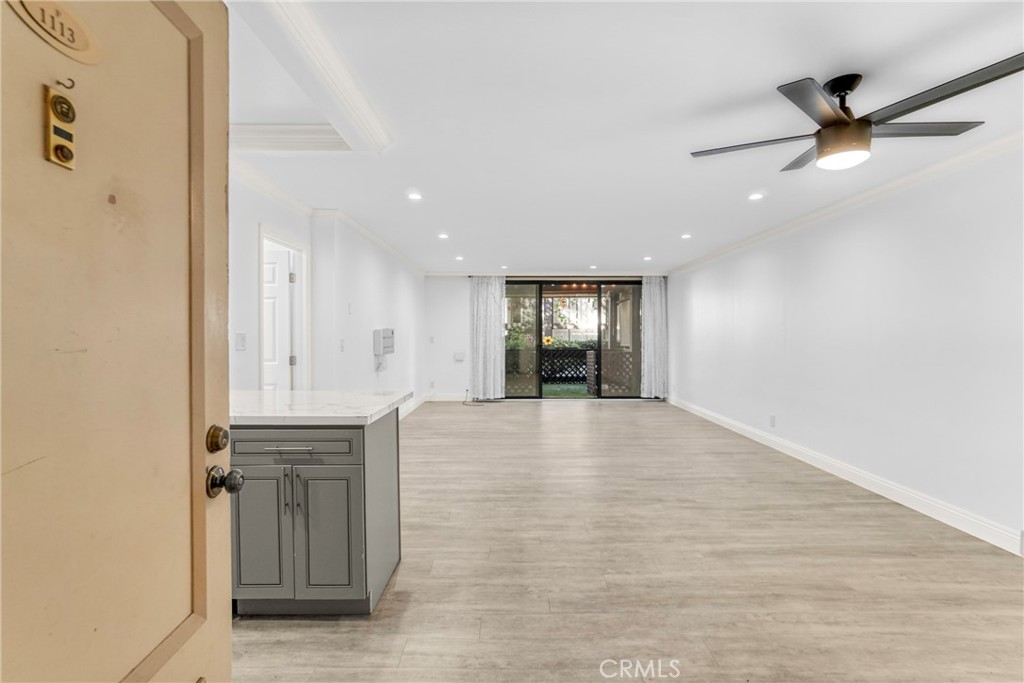7765 West 91st Street, Unit F1113 Playa del Rey, CA 90293 - Photo 6 of 41 a view of an empty room and window and wooden floor