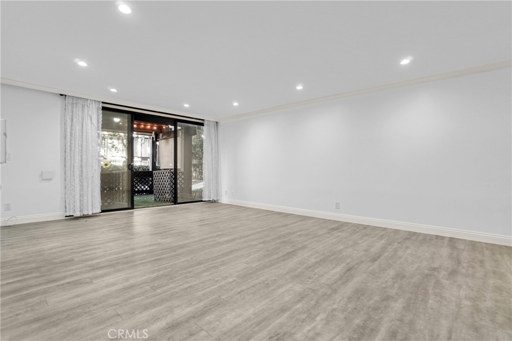 7765 West 91st Street, Unit F1113 Playa del Rey, CA 90293 - Photo 7 of 41 an empty room with wooden floor and natural light
