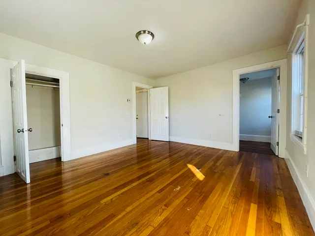 a view of an empty room and wooden floor