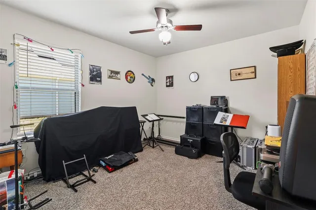 a livingroom with workspace and a window
