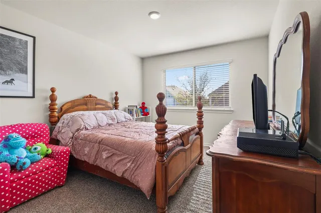 a bedroom with a bed and window