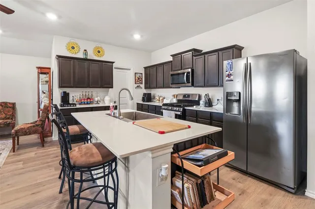a kitchen with a dining table and chairs