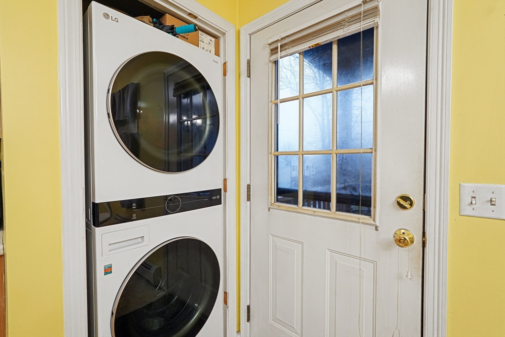 2 Warsaw Avenue, Unit 3 Dudley, MA 01571 - Photo 5 of 12 a view of a hallway with washer and dryer