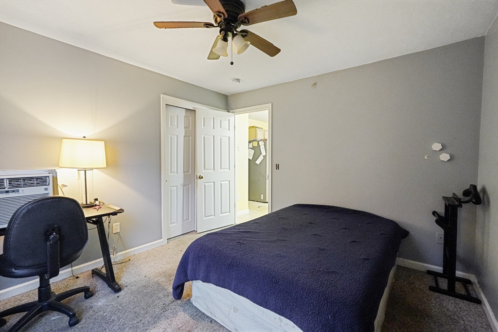 2 Warsaw Avenue, Unit 3 Dudley, MA 01571 - Photo 6 of 12 a bedroom with a bed and a chandelier