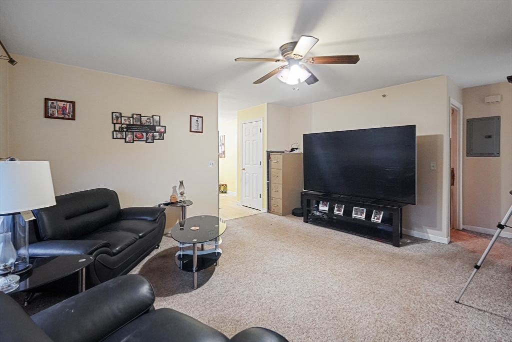 2 Warsaw Avenue, Unit 3 Dudley, MA 01571 - Photo 9 of 12 a living room with furniture and a flat screen tv