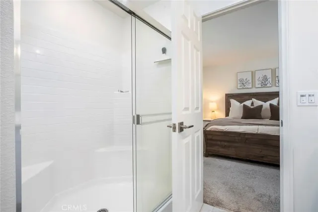 a bedroom with a bed and a painting on the wall