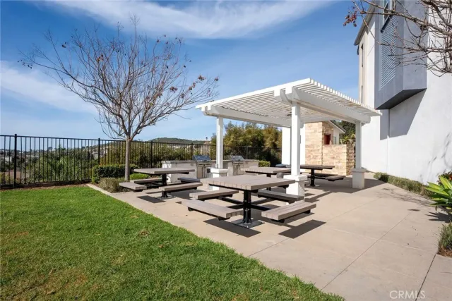 a view of a patio with chairs and table under an umbrella