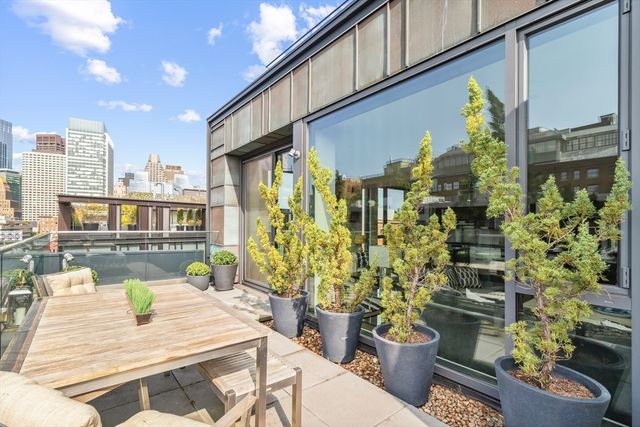 a front view of a house with outdoor seating