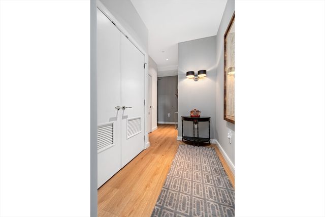 a hallway with a white couches and chairs