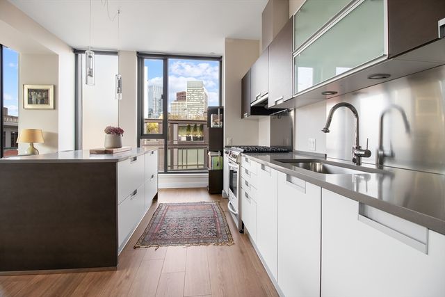 a view of a kitchen with a sink and cabinets