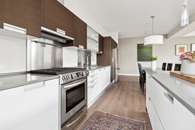 a kitchen with stainless steel appliances granite countertop a stove and a refrigerator