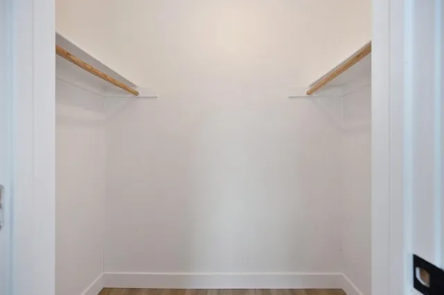 a bathroom with a toilet a sink a mirror a bathtub and vanity