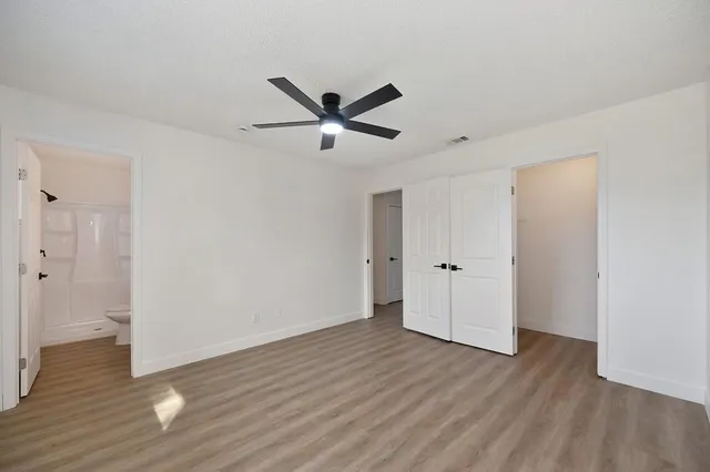 a kitchen with a sink cabinets and wooden floor