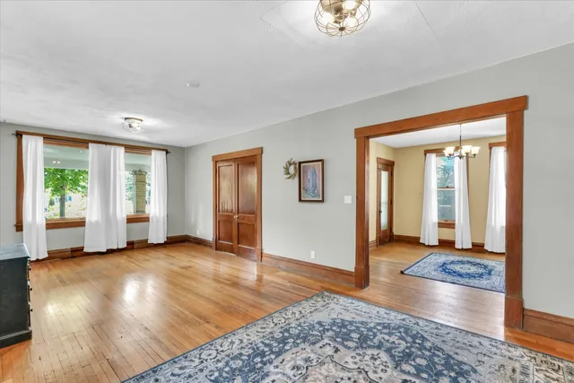 a view of a big room with wooden floor windows and closet
