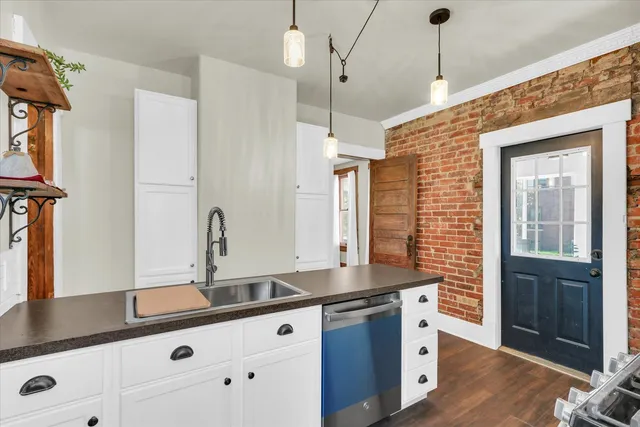 a kitchen with granite countertop a sink and cabinets