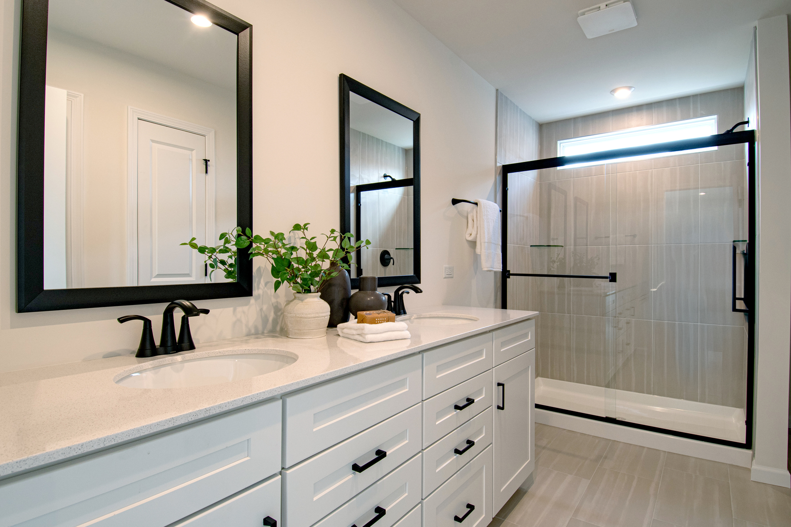 2244 Quartet Road Plainfield, IL 60585 - Photo 12 of 18 a bathroom with double vanity sink a mirror a glass door a shower and vanity