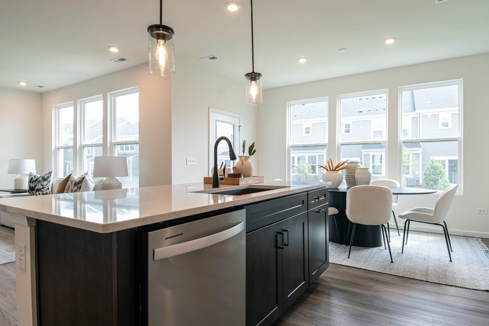 2244 Quartet Road Plainfield, IL 60585 - Photo 5 of 18 a kitchen with granite countertop a sink appliances and living room next to a large window