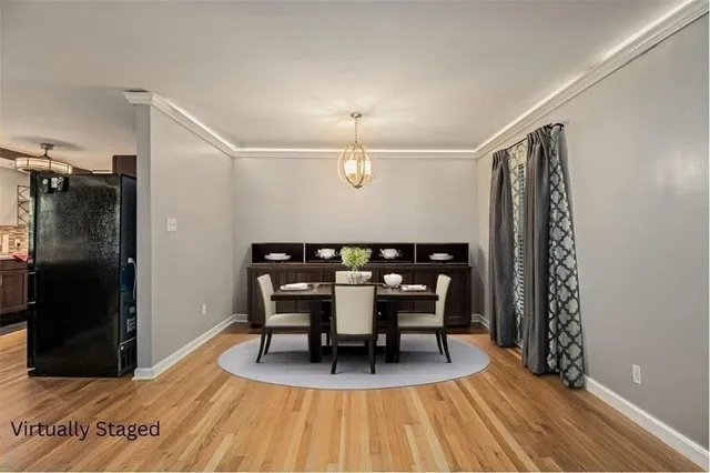 a bedroom with a large bed and a potted plant