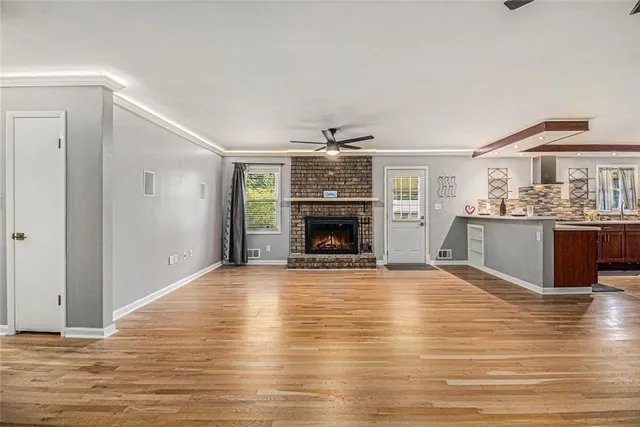 a large kitchen with stainless steel appliances kitchen island granite countertop a sink dishwasher stove and oven