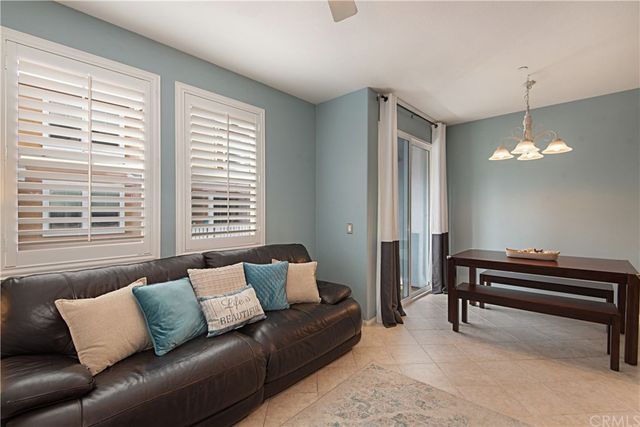 a living room with furniture and a piano