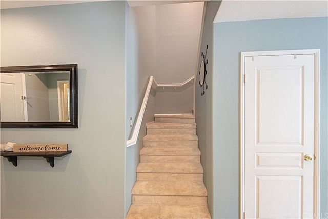 a view of a hallway with entryway wooden floor and front door