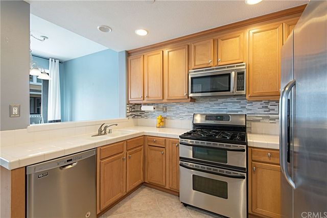 a kitchen with a sink stove and microwave
