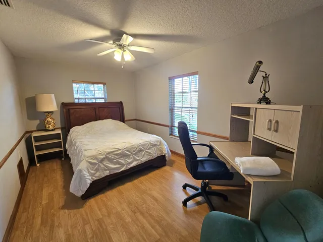a spacious bathroom with a double vanity sink toilet and shower
