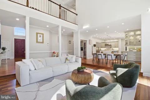 a living room with furniture and a view of kitchen